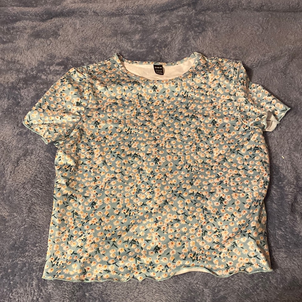 a floral tee shirt, never worn and no stains